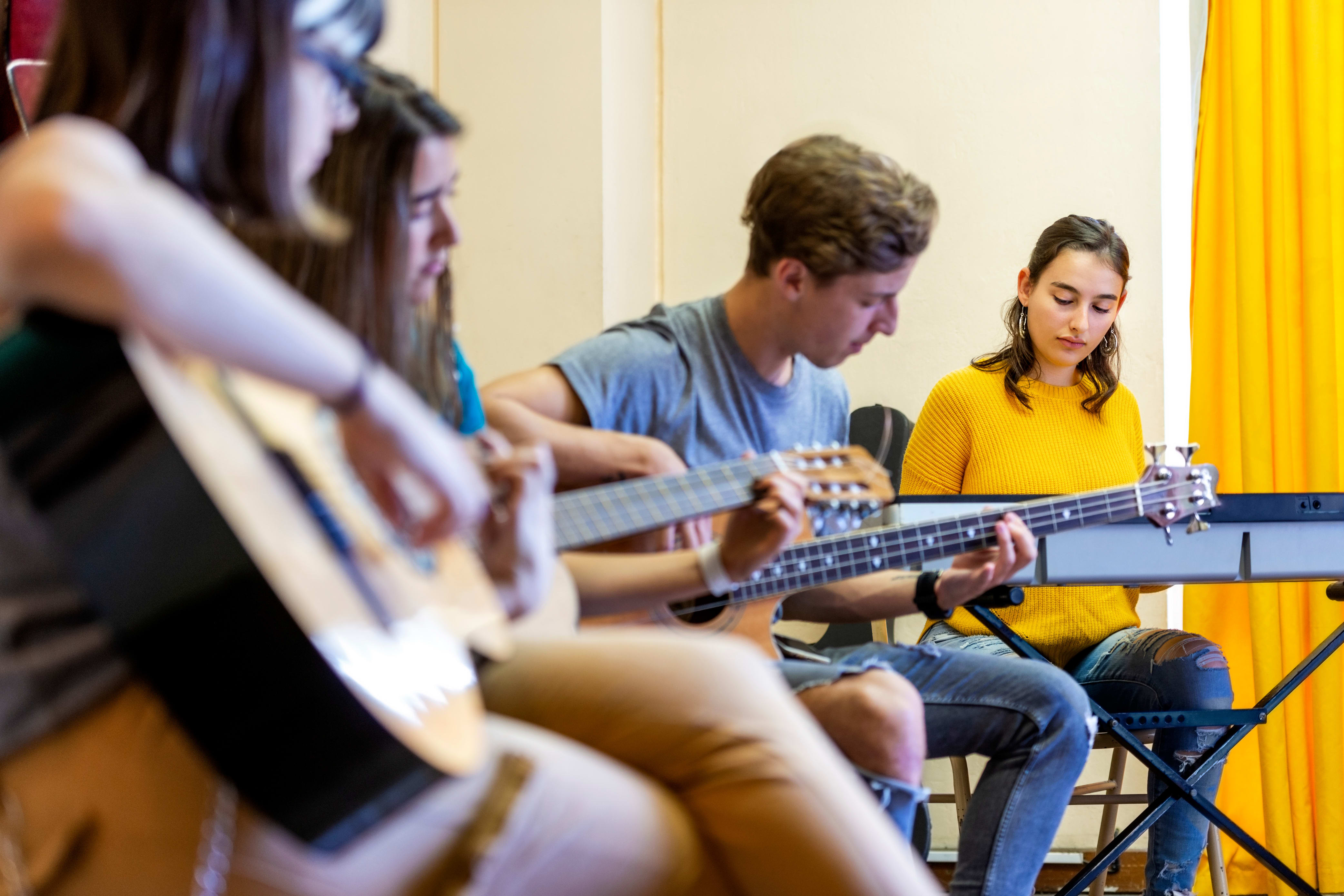 group of four music students practicing together