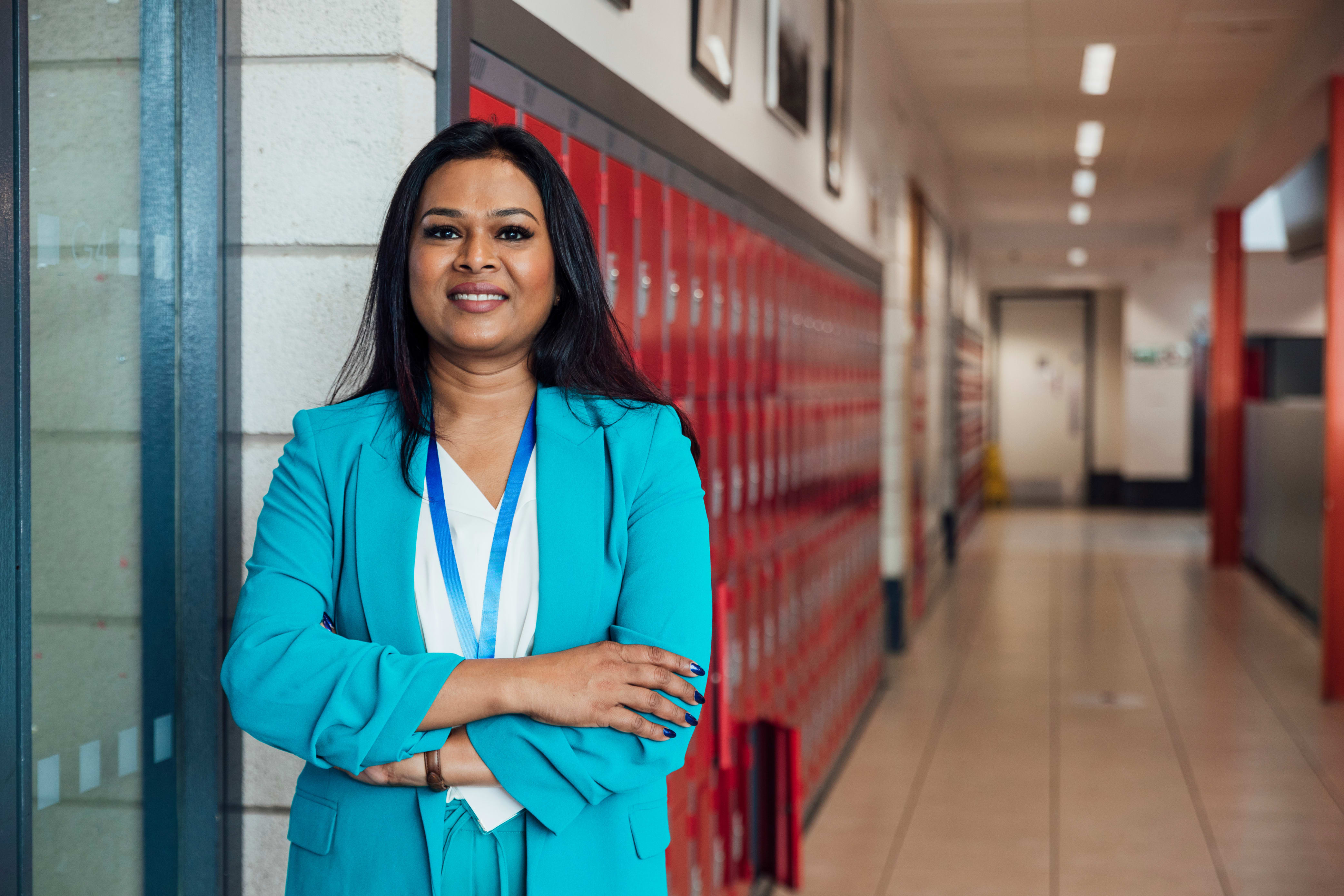 high school teacher standing outside a classroom
