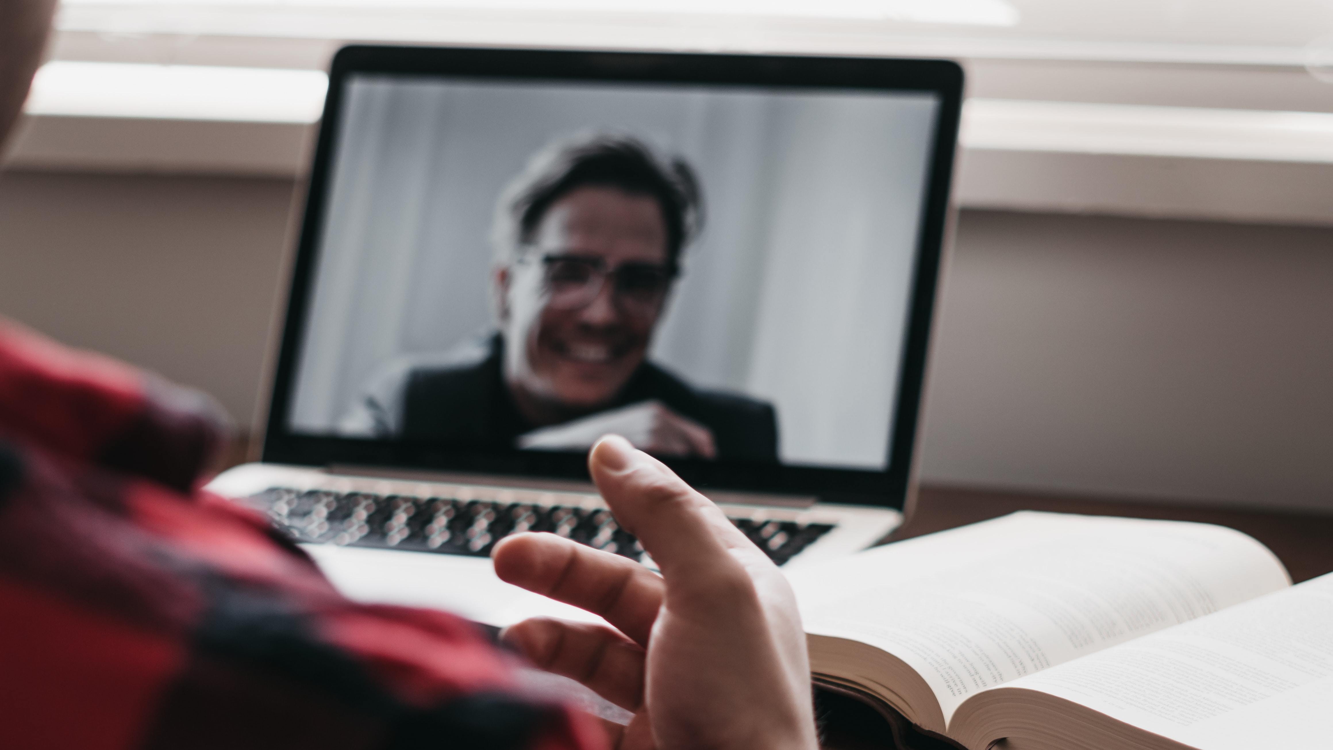 Student on a video call with college admissions consultant