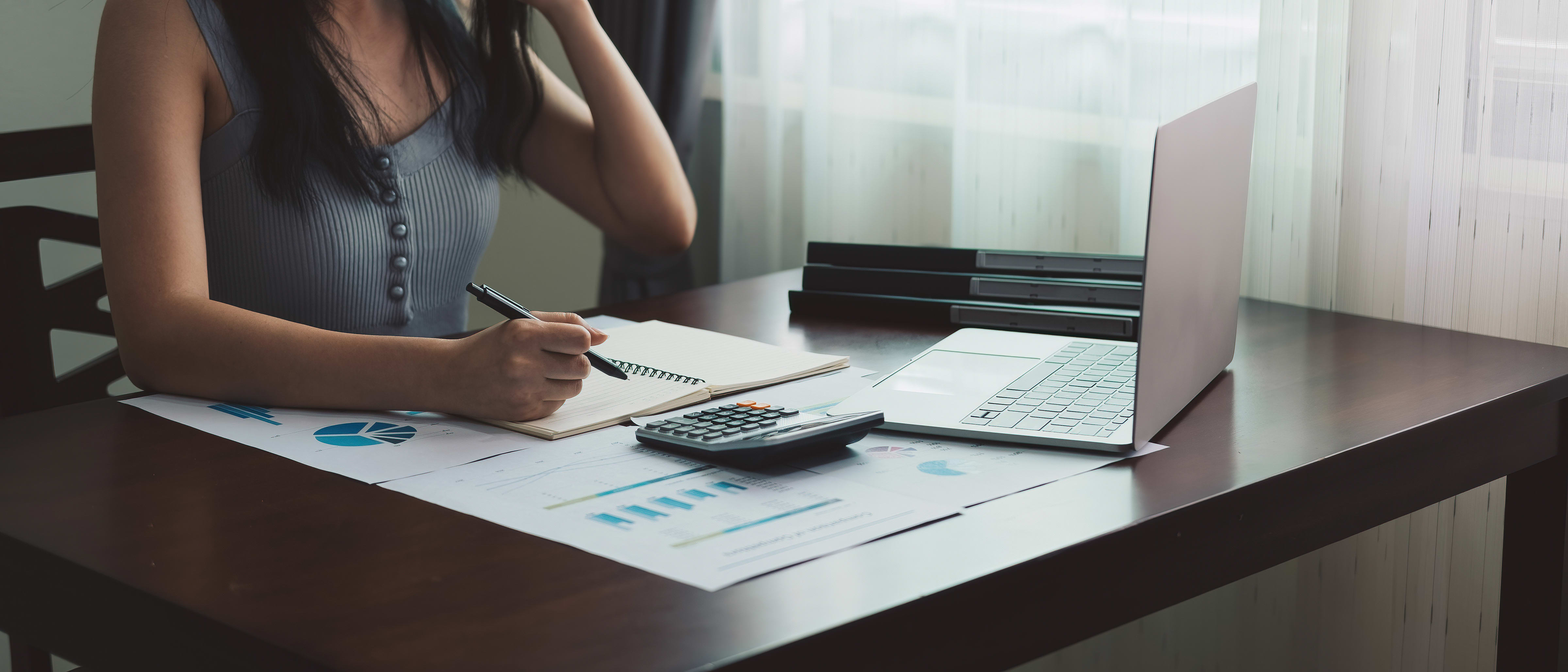 Woman studying accounting by a window