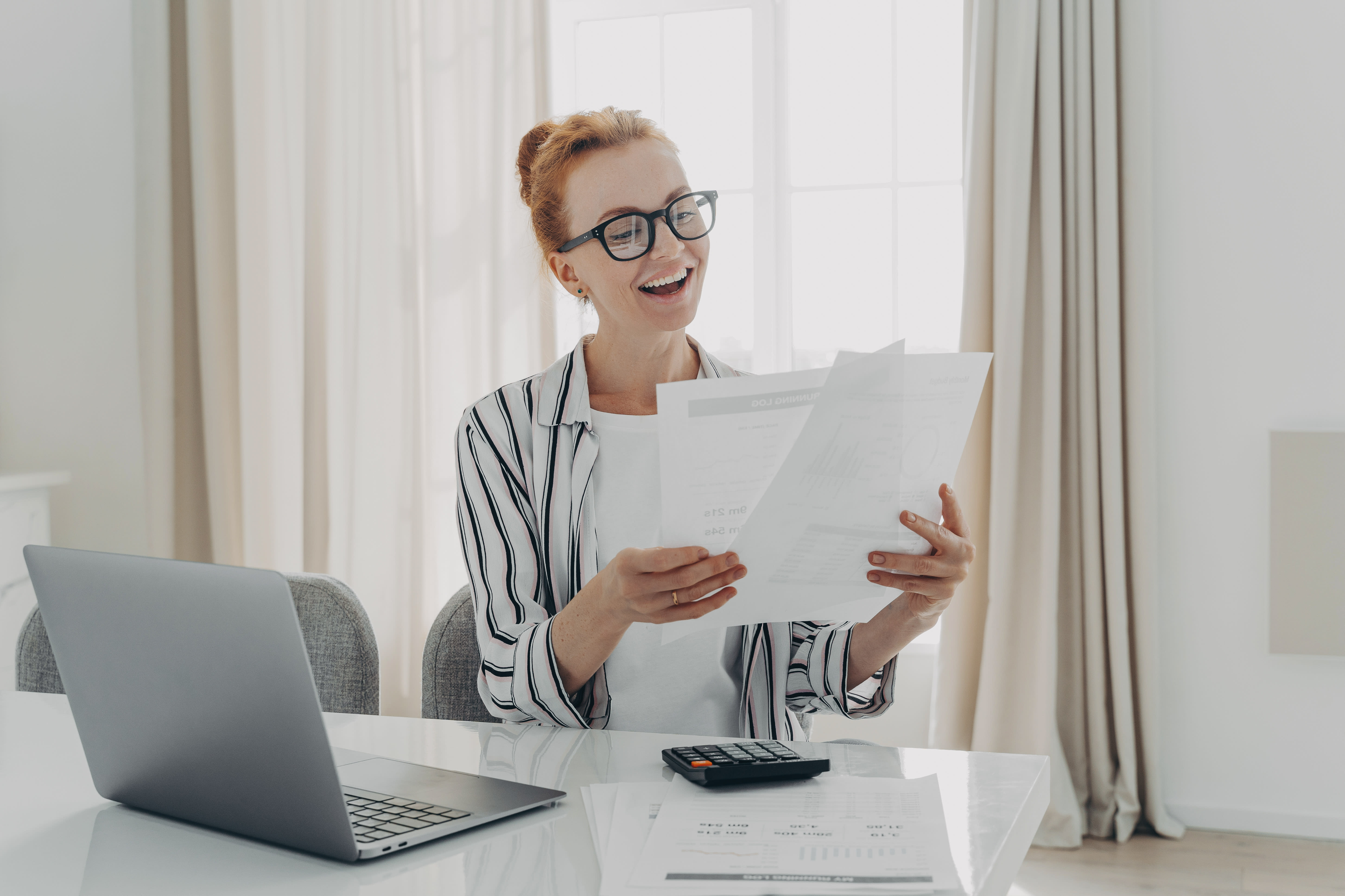 Female accountant in glasses with a calculator