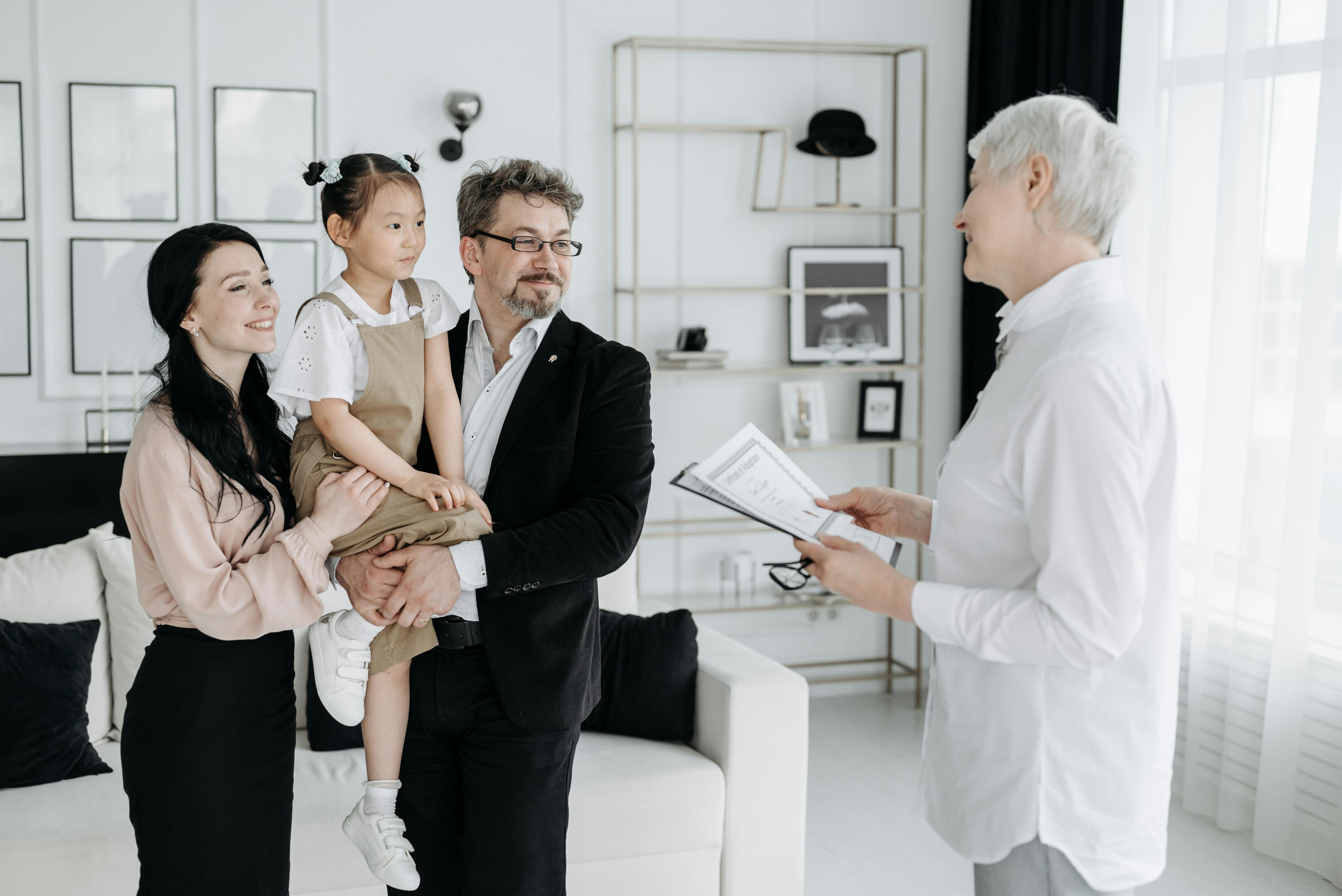 Social worker holding printed reports while talking to a family