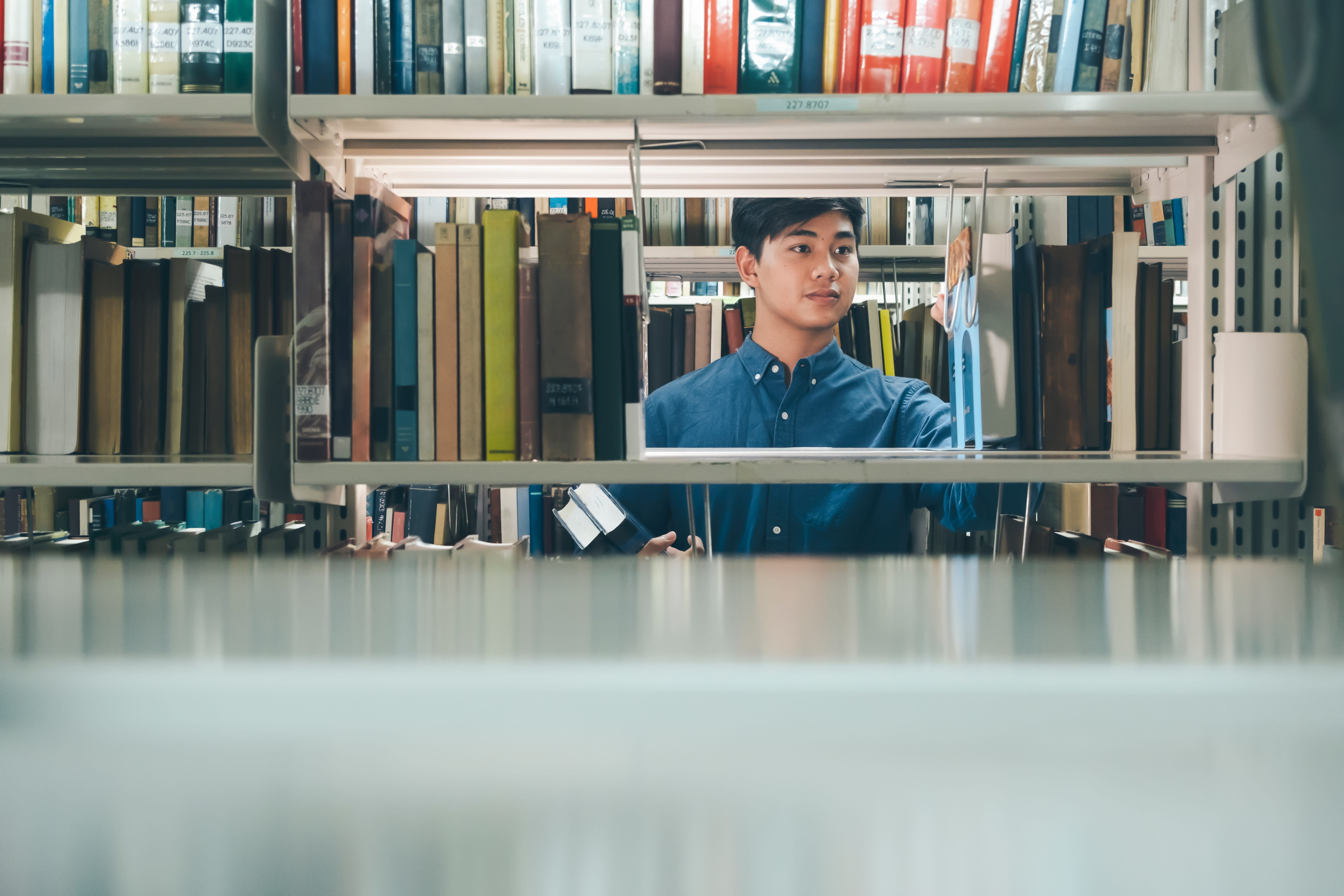 Man choosing a book in a library