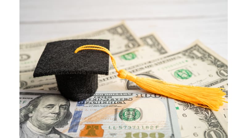 Graduation cap on U.S. dollars