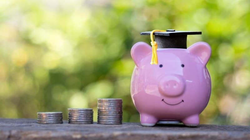 Piggybank with a graduation cap