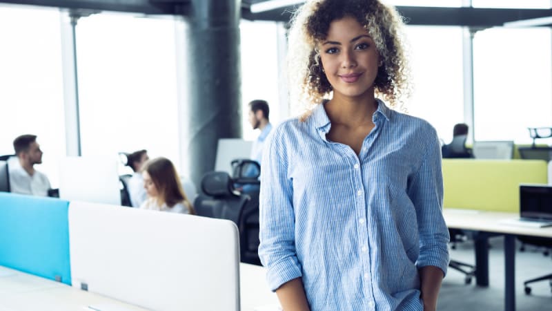 Woman smiling next to a laptop