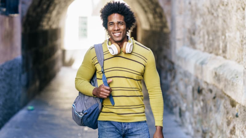 Male student walking through a tunnel