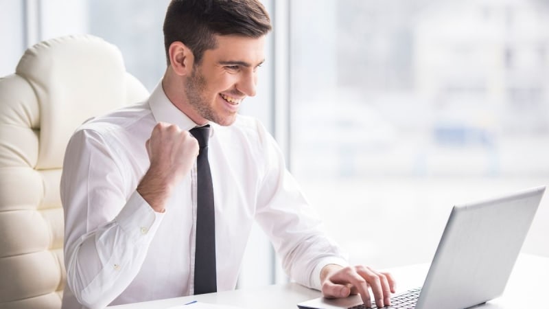 Excited business man on laptop