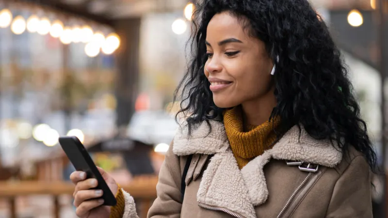 Woman on her phone smiling