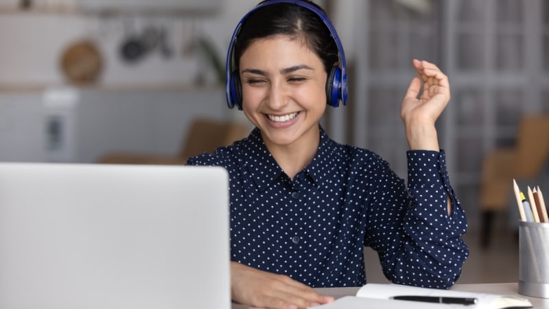 Woman smiling at her laptop