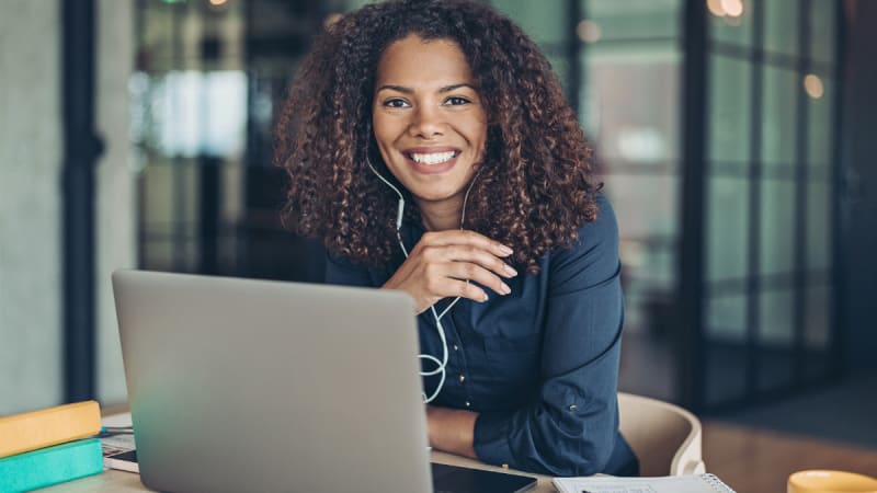 Woman smiling on a laptop