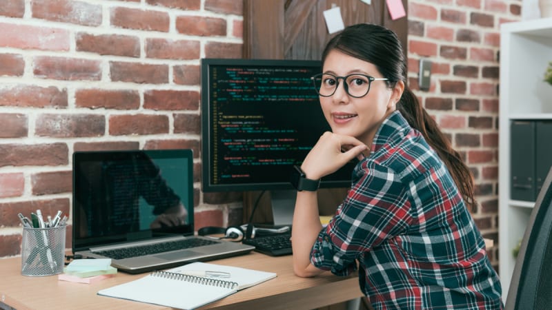 Woman at a desk with glasses