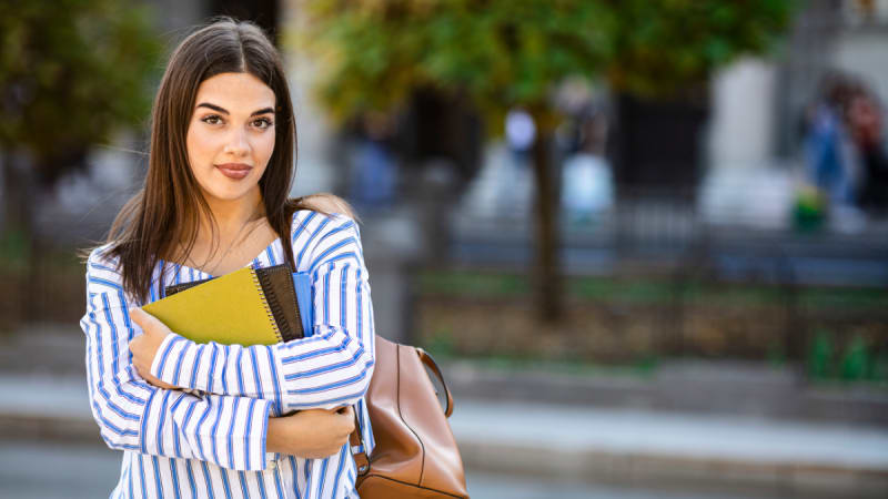 Woman holding notebooks