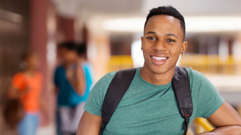 Smiling student in college building