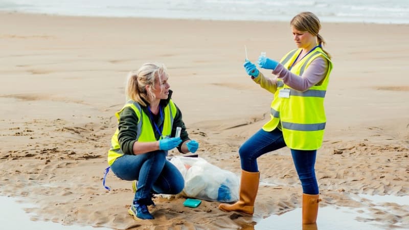 Two environmental scientists performing water analysis