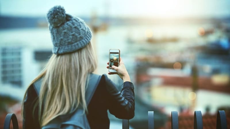 Student taking a picture with a cell phone